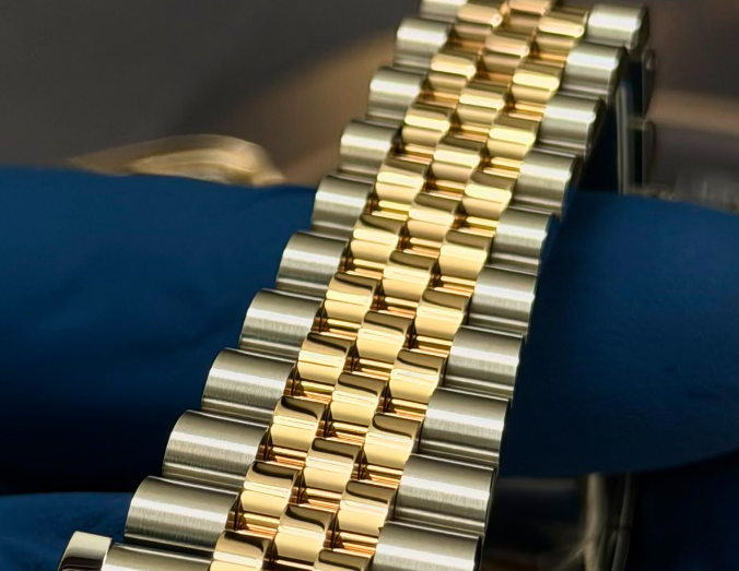 Macro detail of a freshly replated two-tone yellow gold jubilee bracelet