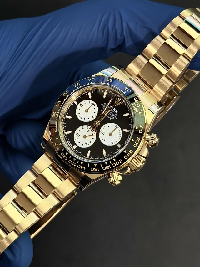 Full watch replating in yellow gold, on the wrist, showing bracelet and chronograph dial